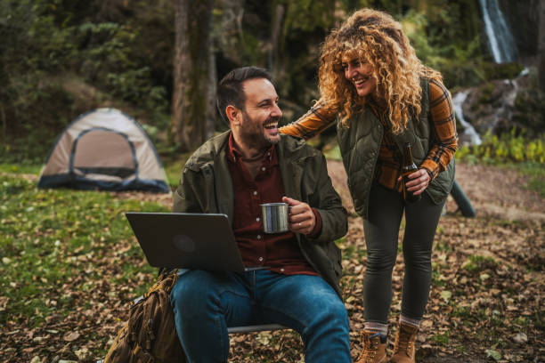 istock wife take care and bring coffee to her husband while he work on laptop 2184358375
