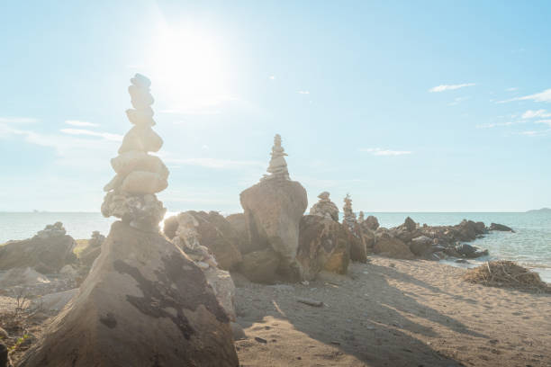 istock Rock formations on the beach at sunset 2184360529