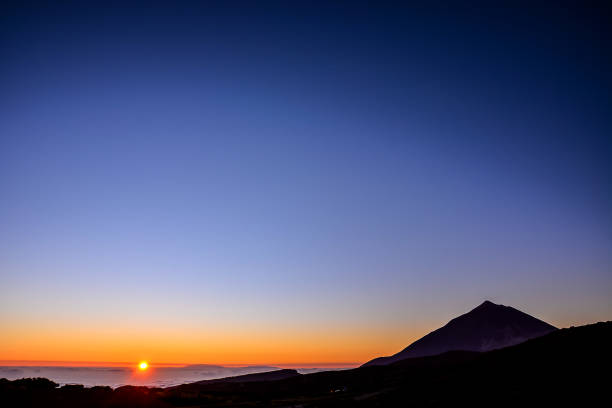 istock The sky is clear and the sun is setting, creating a warm and peaceful atmosphere 2184360532