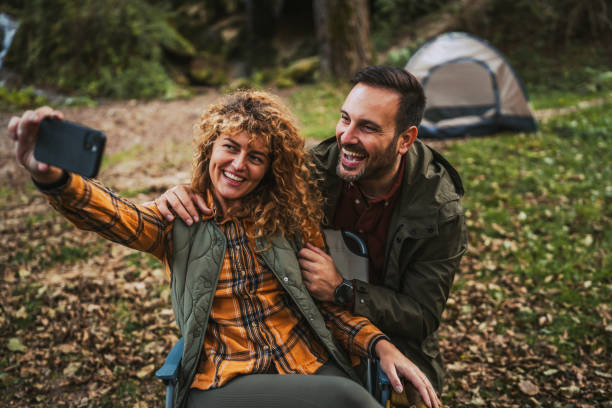 istock happy couple take a self portrait or have video call in front tent 2184361208
