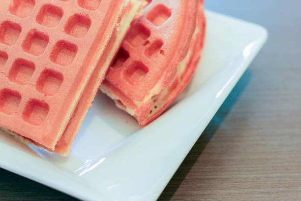 A plate of waffles, a common dessert with whipped cream inside; modern people are paying more and more attention to healthy diet, so they cannot often eat such delicate snacks.