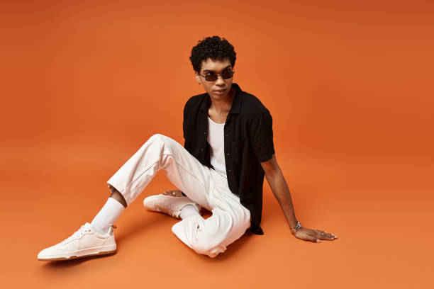 istock Stylish young man showcasing fashion sense in a vibrant studio setting during daytime 2184365621