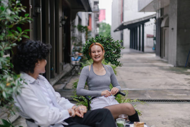 istock Smiling couple having coffee outdoors - stock photo 2184366225