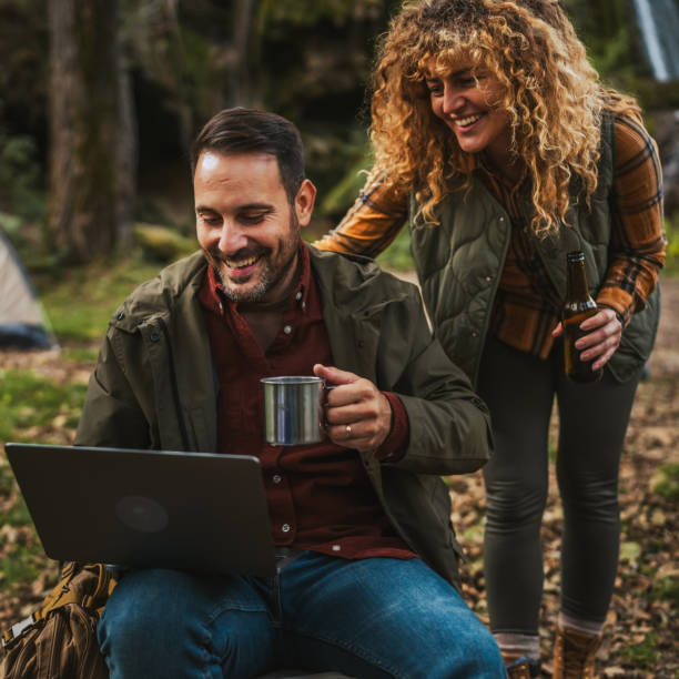 istock wife take care and bring coffee to her husband while he work on laptop 2184367828