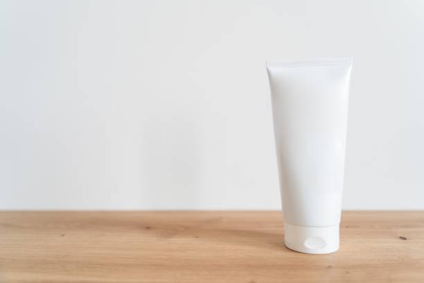 istock White tube cream mockup on a wooden table. 2184367853