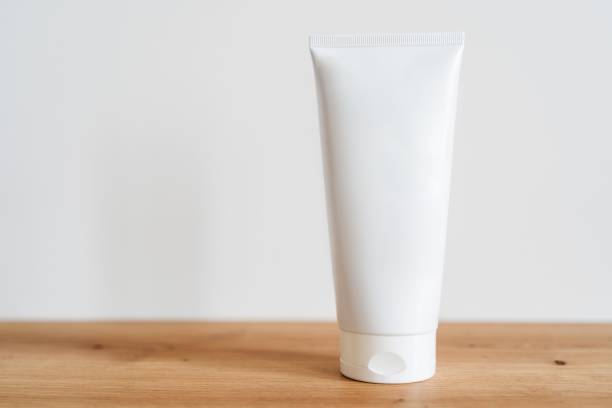 istock White tube cream mockup on a wooden table. 2184367902