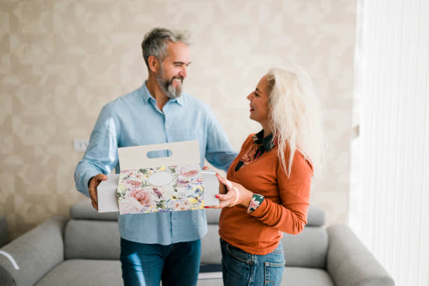 istock Husband at home surprising his  wife with a gift 2184368259