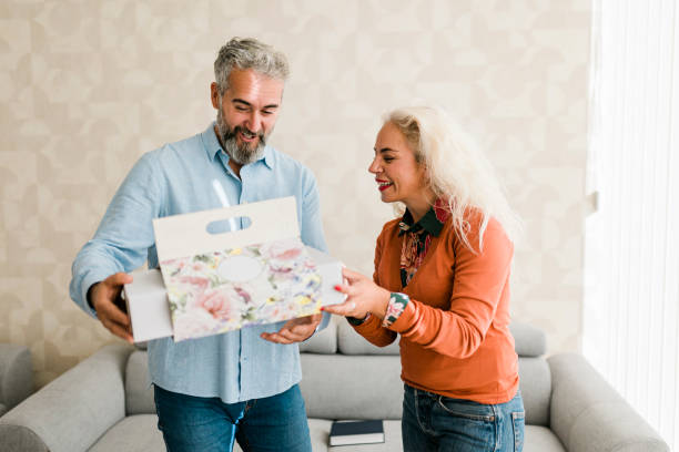 istock Husband at home surprising his  wife with a gift 2184368279