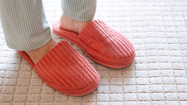 istock Slippers on soft white carpet in living room. Space for text 2184369058