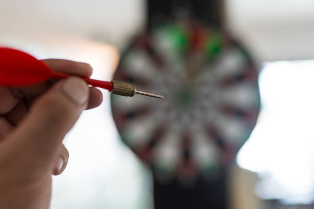 Male hand holding a red darts. Showcasing precision and skill
