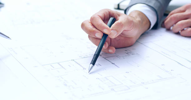 istock Architecture, person and hands on paper for planning, building blueprint and urban development in office. Man designer, pen and illustration in firm for brainstorming, sketching and engineering idea 2184371276