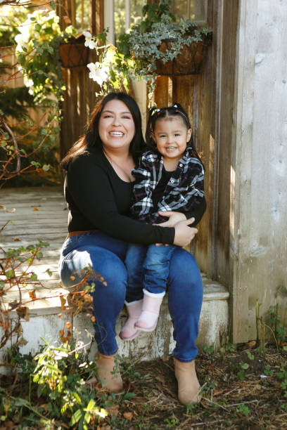 istock Little Girl and Mom on a Charming Rustic Porch 2184371693