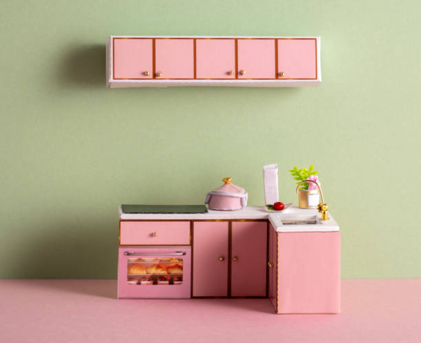 istock A small kitchen model made of paper on a pink and green background 2184374237