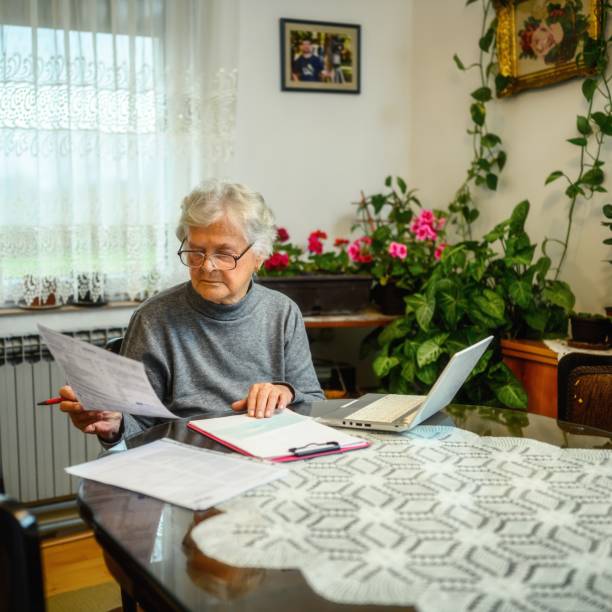 istock Seinor woman paying bills 2184375327