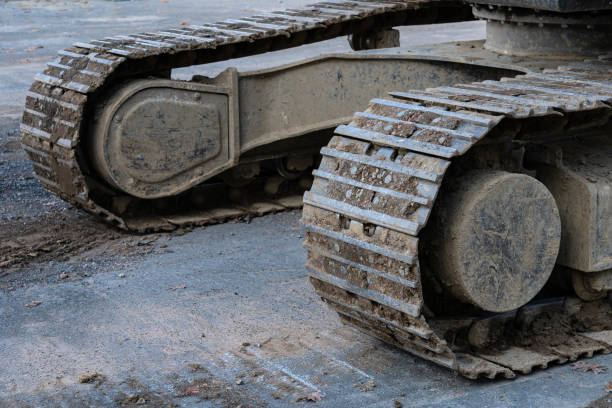 istock Heavy machinery track resting on a construction site in daylight 2184377765