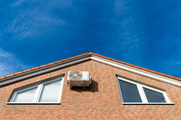 istock Air conditioning unit mounted on a brick house under a clear sky 2184378431