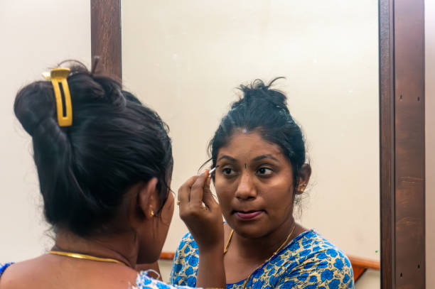 istock A South Asian woman applies makeup 2184379414