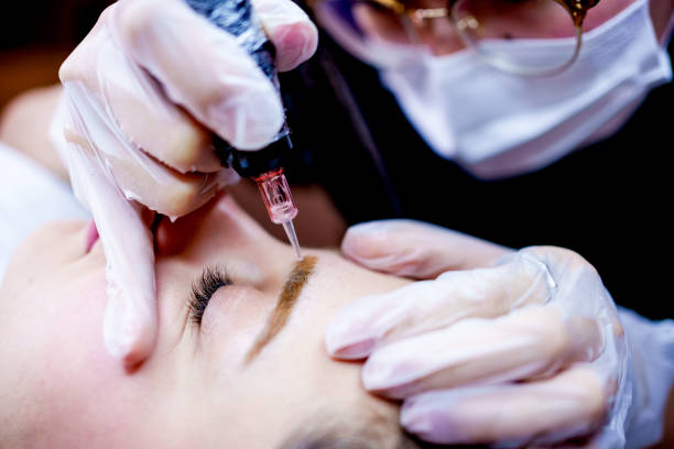 istock young woman receiving permanent make up 2184381723