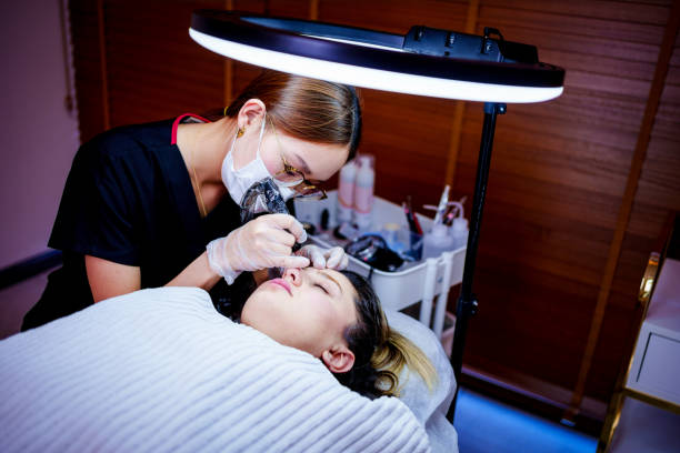 istock young woman receiving permanent make up 2184382079