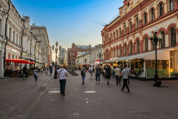 Moscow, Russia - 27, August, 2024.\nEvening walk along the legendary old Arbat.\nPeople stroll along the cobblestone pavement of Arbat.