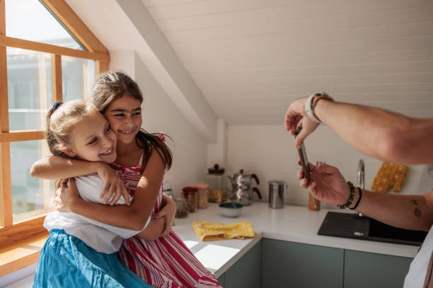 istock Little girls hugging for picture 2184386491