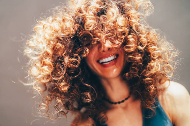 Woman with curly hair taking selfie