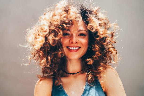 istock Woman with curly hair taking selfie 2184389718
