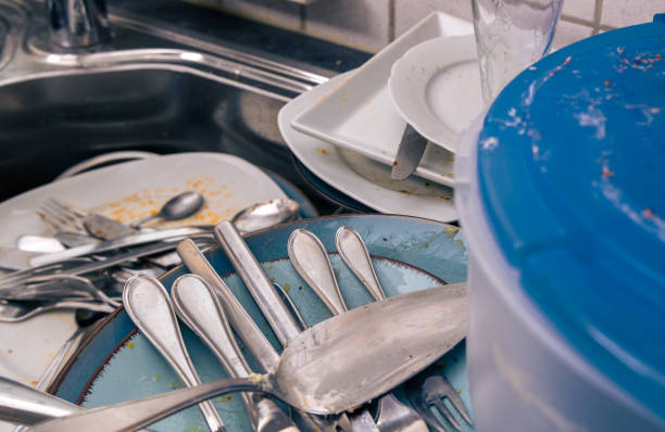 istock dirty dishes in and around kitchen sink 2184390024