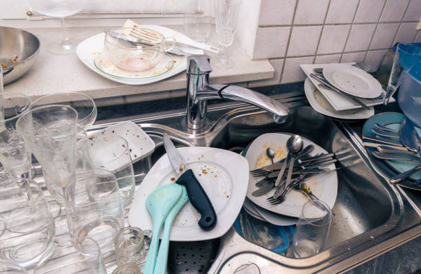 istock dirty plates and cutlery in kitchen sink, close up 2184390084