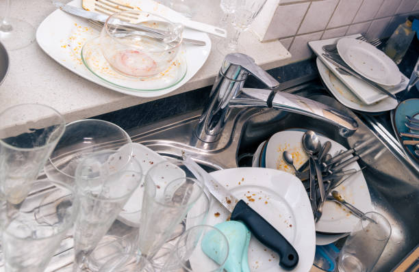 istock view on kitchen sink filled with dirty dinnerware and glasses 2184390111