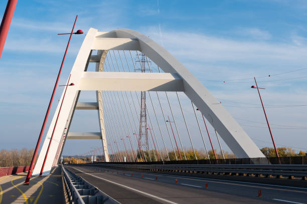 istock Pentele Bridge, the modern arch bridge with red lamp posts and cable support 2184391338