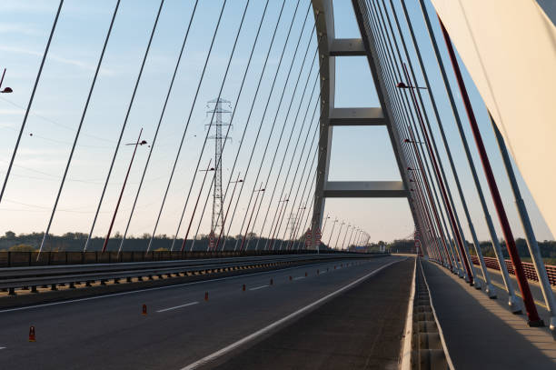 istock Perspective view of the Pentele Bridge with cables and lamp posts 2184391427