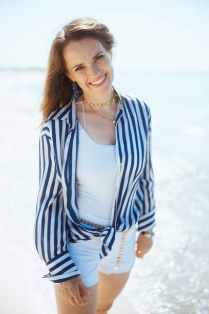 istock happy stylish woman on ocean coast having fun time 2184393642