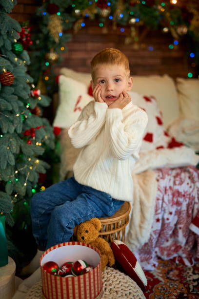 istock Cute little boy next to Christmas tree 2184398357