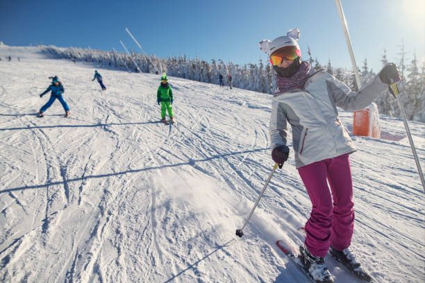 istock Happy family skiing on snowy slope 2184398743
