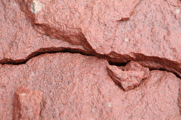 A vibrant image showing the texture and cracks of red rock, perfect for geology fans and design use