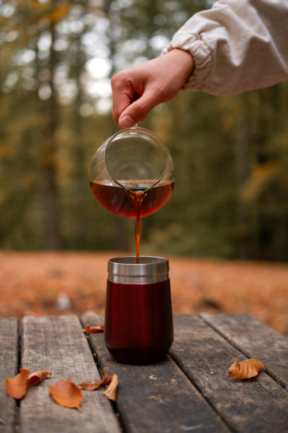 istock brewing coffee in nature. Autumn themed. 2184400613