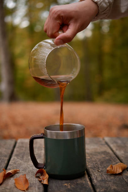 istock brewing coffee in nature. Autumn themed. 2184400614