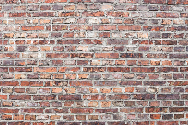 istock Brick wall background. Urban rustic texture with red bricks. Antique house exterior wall. 2184400969