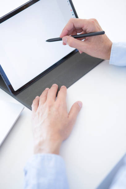istock Woman's hands working with her tablet in her office 2184401392
