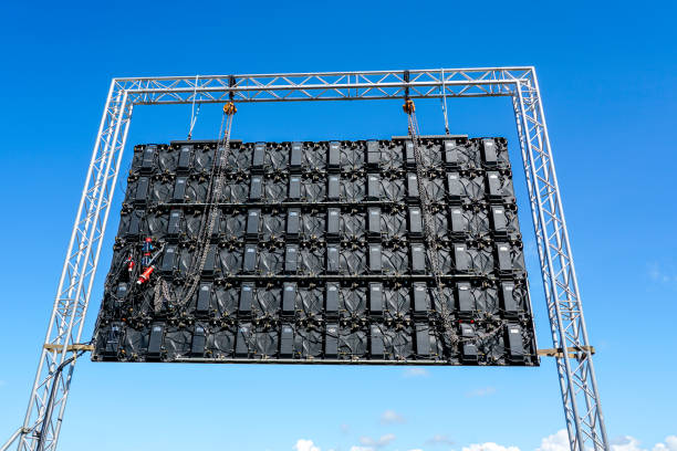 istock Large outdoor event LED display in metal structure frame on blue sky background, rear view 2184401892