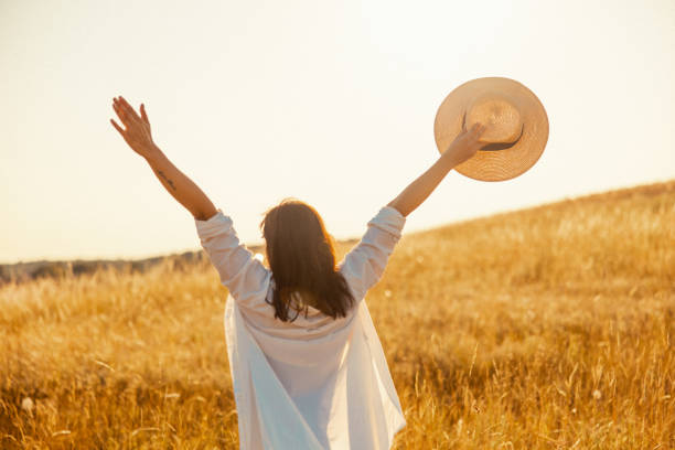 istock Euphoric Woman Embracing Nature in Open Field 2184402357