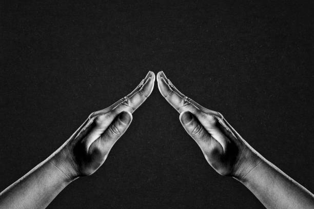istock Hands in Gesture of Protection, Care Sign on Black 2184405352