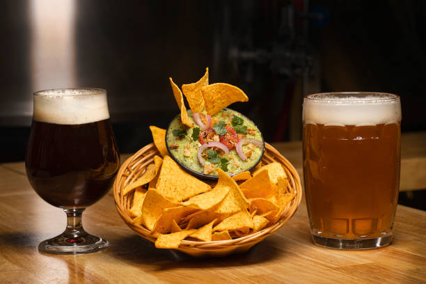 Enjoy Craft Beer paired with Crispy Nachos and Fresh Guacamole for the Perfect Snack Experience