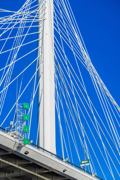 Close-up of the suspension Bridge cables of the Alamillo bridge against a blue sky in Seville, Spain