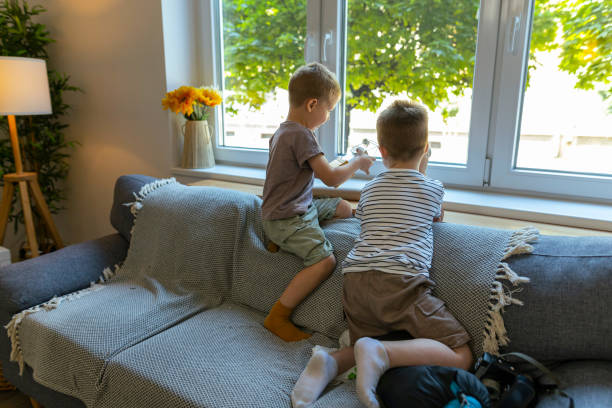 istock Two brothers exploring outside,  with the help of cardboard binoculars 2184411685