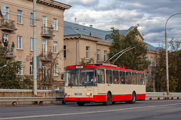 Lithuania, Vilnius - September 28, 2018 - An old trolleybus with passengers rides along an empty road. Old orange buildings against the background of a trolleybus. Trolleybus close-up.