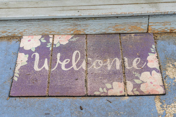 Weathered welcome sign outside a beach cottage.