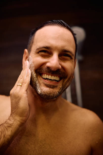 istock Happy man washing his face under the shower. 2184415584