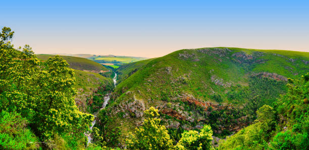 Panorama shot of Tradouw River running in the gorge of Langeberg Mountains during a blue sky, white cloud afternoon, Suurbraak, Overberg, Western Cape, South Africa